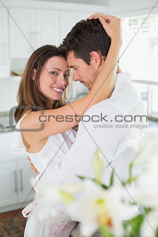 Portrait of a loving young couple in kitchen