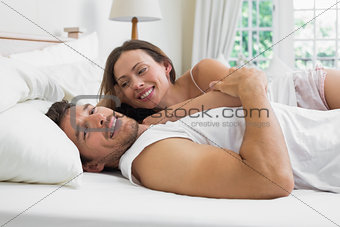 Happy relaxed couple together in bed