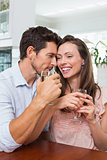 Happy couple with wine glasses at home