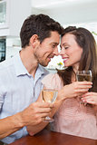 Loving couple with wine glasses at home