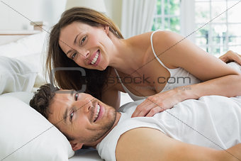 Happy relaxed couple together in bed