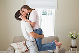 Young man kissing woman at home