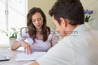 Young couple sitting with home bills at table