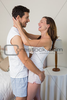 Loving couple looking at each other at home