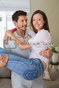 Man carrying woman at home