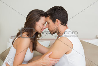 Loving couple with eyes closed at home