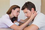 woman consoling a sad man at home