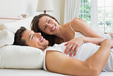 Relaxed young couple lying in bed
