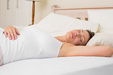 Relaxed woman sleeping in bed