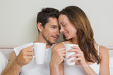 Happy relaxed couple with coffee cups