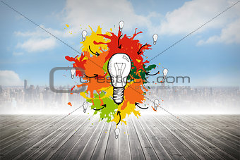 Composite image of light bulb on paint splashes