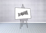Composite image of teamwork text on easel