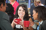 Grinning Woman with Coffee and Coworkers