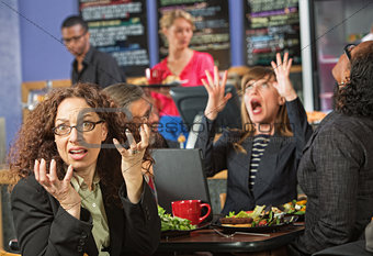 Surprised Executives in Cafe