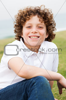 Smiling young boy posing casually 