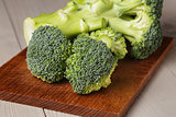fresh broccoli on wood cutting board