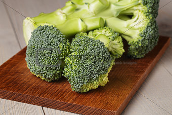 fresh broccoli on wood cutting board