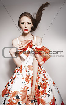 young beautiful asian brunette in gorgeous dress, motion shot, f