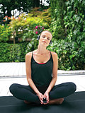 woman in earphones doing yoga ri
