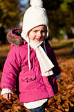 cute littloe girl playing outdoor in autumn