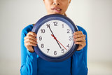 asian girl holding big blue clock with stress