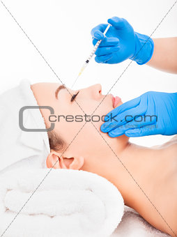 Beautiful woman gets injection in her face
