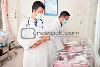 gynecologist doctor holding a newborn baby