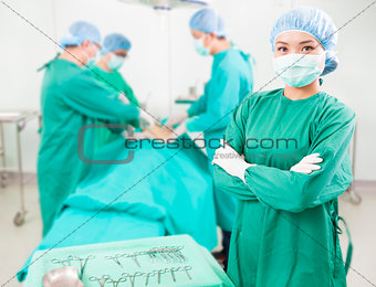 surgeon standing in front of a colleague in a surgical room