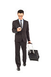  businessman walking and using phone  with briefcase 