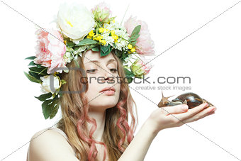pretty girl with snail and flower crown on head