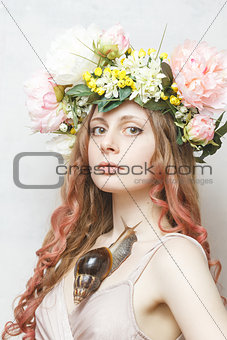 calm pretty girl with snail and flower crown on head 