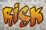 risk word graffiti on plaster wall