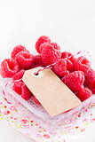 Fresh raspberries and cardboard tag