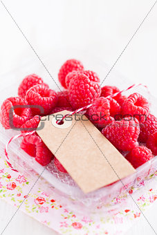 Fresh raspberries and cardboard tag