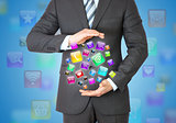 Businessman in a suit holding a app icons