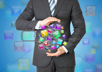 Businessman in a suit holding a app icons