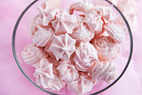 Pink meringues in a glass bowl 