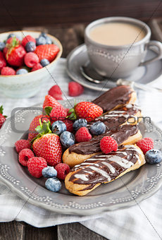 Chocolate eclairs with fresh berries