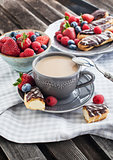 Cup of coffee and chocolate eclairs