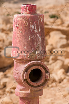 Red fire hydrant on the background of the stones