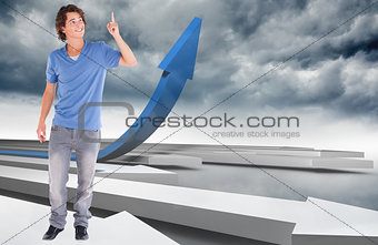 Composite image of handsome guy pointing