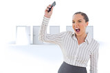 Composite image of offended businesswoman screaming and throwing her mobile phone