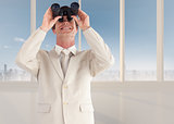 Composite image of confident businessman with binoculars