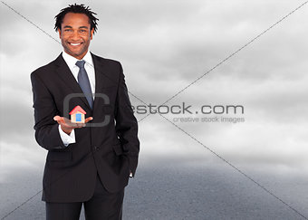 Composite image of businessman with house for real estate concept