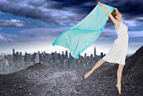Composite image of young beautiful female dancer with blue scarf