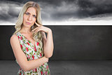 Composite image of frowning pretty blonde wearing flowered dress posing