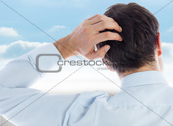 Composite image of businessman scratching his head