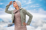 Composite image of concentrated young model in winter clothes watching around her