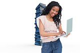 Composite image of a young woman holding a laptop is smiling at the camera