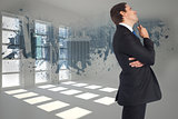 Composite image of thinking businessman holding pen